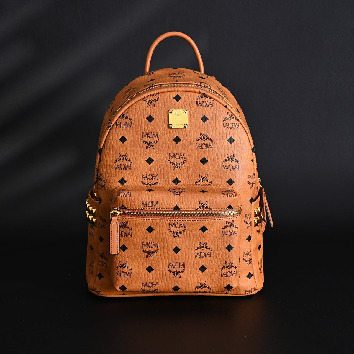Mcm Stark Visetos Medium Backpack – Cognac Monogram with Gold-Tone Studs - Cognac with Black Monogram Print — view 1